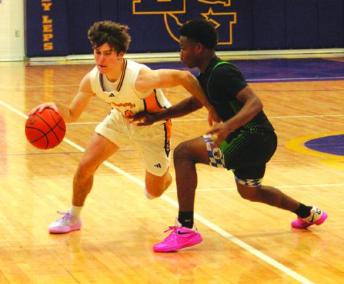 La Grange’s Cordale Knapik drives past a Taylor player in Tuesday’s game. Photo by Jeff Wick