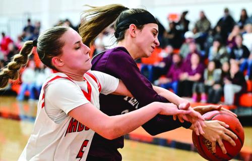 Schulenburg’s Jenna Guentert, left, and Flatonia’s Danielle Vinklarek, right, battle for control of the ball in Tuesday’s district opener. Photo by Stephanie Steinhauser