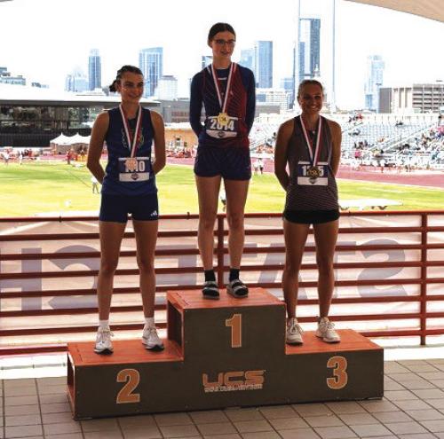 Fayetteville’s Cambree Denham, right, on the medal stand after Saturday’s 1A high jump competition.