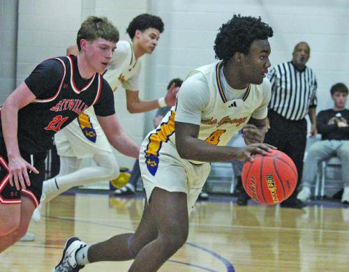 La Grange’s Dillan Johnson leads a fast break Tuesday against Smithville. Photo by Jeff Wick