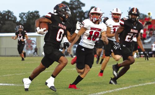 Schulenburg’s Byron Johnson speeds away from a Burton’s Ryder Biggs during Friday’s game. Photo by Darrell D. Gest