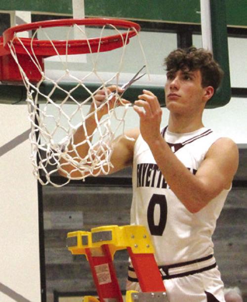 In a thrilling state semifinal victory over Huckabay Monday, the Fayetteville Lions boys basketball team punched their ticket to Thursday’s state title game. After the game all the Lions took turns cutting down a piece of the net, symbolizing that they are the last 1A team standing from Regions III and IV. Here’s Enoch Loafman cutting his piece. More on the historic win on page B1 today. Photo by Jeff Wick