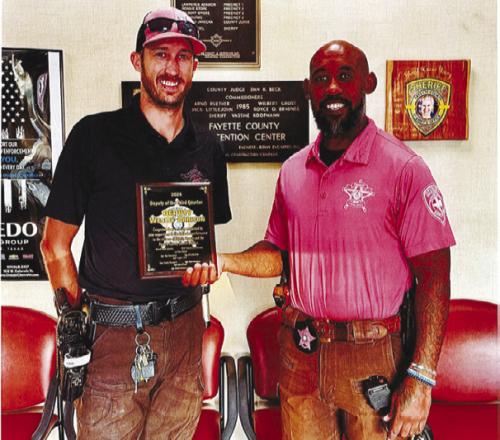 Wesly Arrison, left, receives his award from Sgt. Ben Wilson.