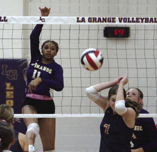 A Caldwell player retreats from a powerful hit by La Grange’s Brion Williams in Tuesday’s match. Photo by Jeff Wick
