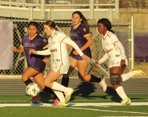 La Grange’s Juliana Vazquez, left, and Melanie Cruz, center fight for control of the ball in Friday’s game. Photo by Jeff Wick