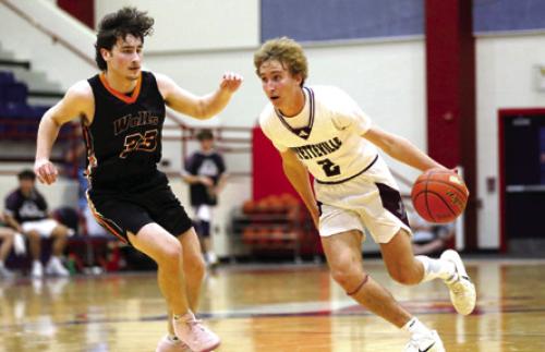 Fayetteville’s Kole Schmitt dribbles past Slade Tarrant of Wells during first-quarter action Tuesday in Madisonville. Photo by Ken Sury