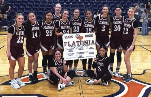 The members of the Flatonia girls basketball team celebrate their opening round playoff win Monday in Caldwell.