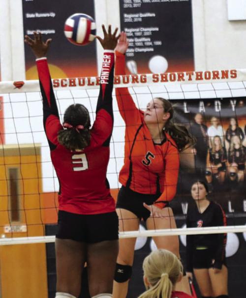 Schulenburg’s Haylee Vacek spikes the ball in Friday’s match against Burton. Photo by Audrey Kristynik