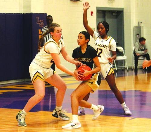 La Grange’s Hannah Gross, left, and Kaylee Holmes, right, double team this Giddings player during district basketball action Friday. Photo by Jeff Wick