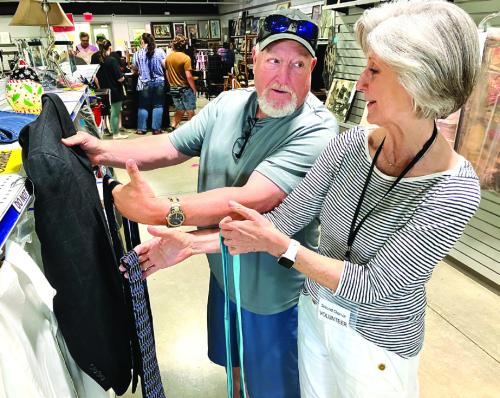 Second Chance volunteer Pam Giese helps Brian Burton pick out just the right shirt and tie combination for an upcoming wedding. Giese is a regular volunteer at the store who, when asked, also gives out sartorial advice, proving once again that you can get just about everything at Second Chance.