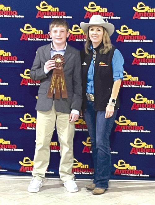Fayette County 4-H Intermediate Team, Kaden Raabe who placed 9th high point, pictured with the SALE Representative.