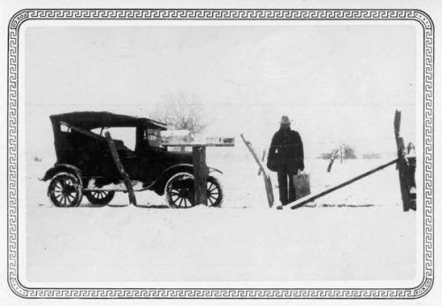 A local mail carrier, possibly John Giese, is shown holding a mail bag and pouch after the Jan. 23, 1926, snowfall.