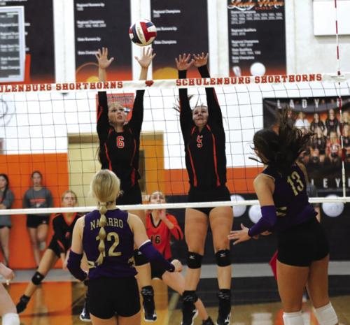 Schulenburg’s Clara Magliolo, left, and Haylee Vacek, right, jump to try to block this Navarro hit Friday. Photo by Audrey Kristynik