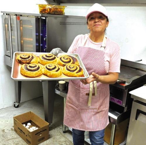 Rosa at Westside Shamrock serving up cinnamon rolls