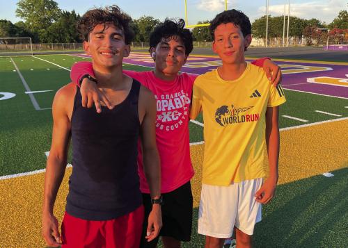 Left to right: Abbot Acosta, Dilan Barron and Jacob Estrada pose after distance practice with the Optimist Summer Track program Monday at Leopard Stadium. Photo by Jeff Wick