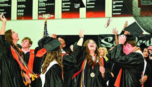 Schulenburg was among the last county schools to hold its graduation ceremonies when it did so Friday at their gym. Above, the grads (including Salutatorian Riley Zapalac, center and valedictorian Blake Helms, right) toss their hats with their fellow grads at the conclusion of the ceremony. Photo by Stephanie Steinhauser