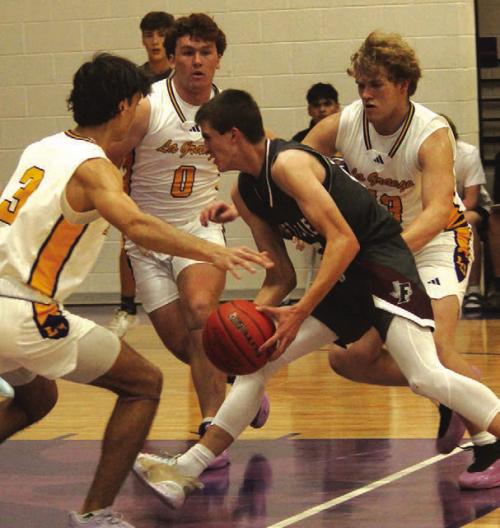 As Fayetteville’s Easton Jaeger drives to the basket Tuesday as La Grange’s Tre Supak, Oliver Gunn and Conner Brooks converge to try to stop him. Photo by Jeff Wick