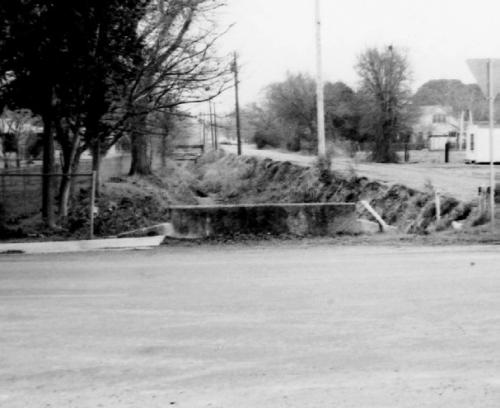 Dr. Leland F. Zatopek took this photograph at the intersection of Jackson Street with Live Oak and Eblin Streets in 1978 before Beef Head Ditch was covered. Photo courtesy of the Fayette Heritage Museum &amp; Archives