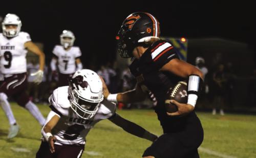 Schulenburg quarterback Aaron Janecek stiff-arms a would-be Kenedy tackler Friday. Photo by Audrey Kristynik