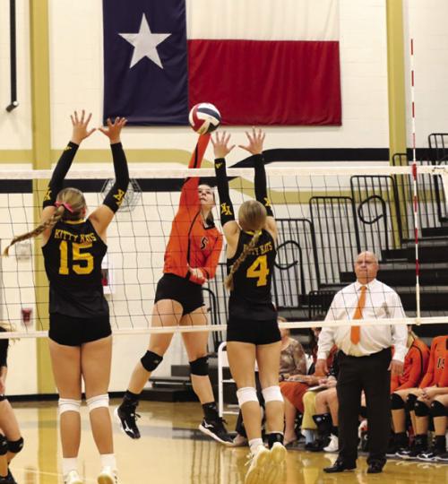 Schulenburg’s Haylee Vacek spikes a ball as head coach Donald Zapalac looks on Thursday. Photo by Audrey Kristynik