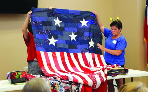 Debbi Gabler with the Quilt of Valor quilts.