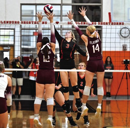 Schulenburg’s Reagan Dusek goes up for a hit while Flatonia’s Abby Uzzell and Quinn Arnett go up for the block. Photo by Stephanie Steinhauser