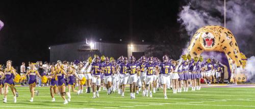 The members of the La Grange football team run onto the field at the start of Friday’s game. Photo by Andy Behlen