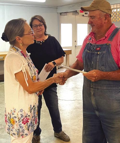 Cedar Creek Schuetzen Verein received donations from the Carmine Chamber of Commerce and the Carmine Lions Club for the purchase of new chairs for the Carmine Hall. Marie Loewe, left, Secretary/Treasurer for the Lions Club presented $2,020 and Marlene Waak, center, President of the Chamber presented $2,000 to Stuart Markwardt, right, President of the Carmine Hall at their May meeting.