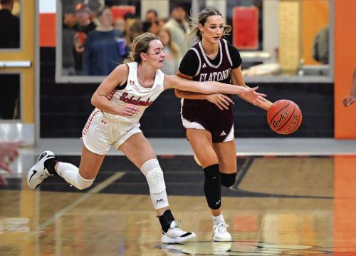 Summer Sodek advances downcourt with pressure from Schulenburg’s Miranda Bonner. The Flatonia Lady Bulldogs defeated The Schulenburg Lady Shorthorns 80-47 on Tuesday night in Schulenburg. Photo by Stephanie Steinhauser