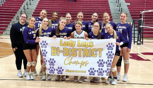 The members of the La Grange volleyball team celebrate after Thursday’s opening round playoff victory over Katy Freeman.