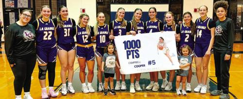 La Grange junior Campbell Cooper reached the 1,000-point mark for her high school career in Tuesday’s win at Cedar Creek. She’s shown here, center, celebrating with her teammates.