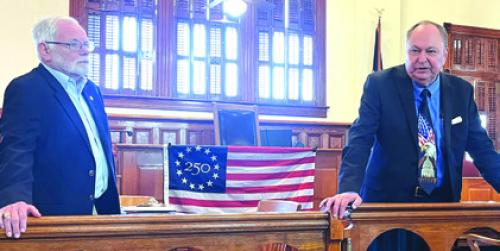 Larry Jackson, left, chair of the America 250 events here in Fayette Co., and Co. Judge Dan Mueller, right, speak at last week’s meeting.