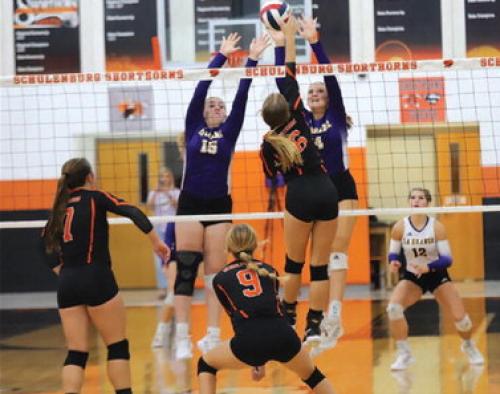 La Grange's Hannah Gross and Avery Grib n try to block the spike of Schulenburg's Clara Magliolo in Friday's match. Photo by Audrey Kristynik