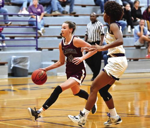 Flatonia’s Summer Sodek drives to the basket against the defense of La Grange’s Tori Harold. Photo by Stephanie Steinhauser