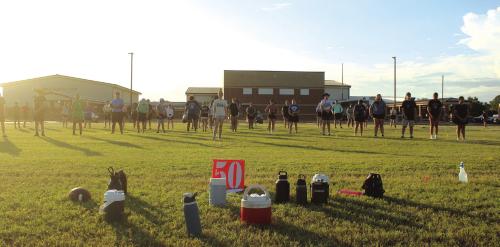Water bottles dot the area around the 50-yard line on the band’s marching practice field as the sun begins to set during the band’s practice Friday evening. Photos by Jeff Wick