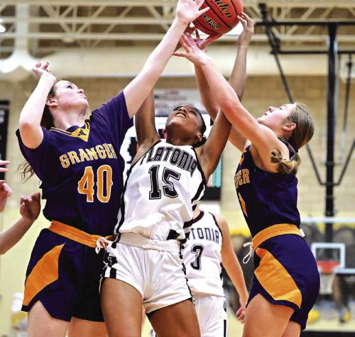 Kalen Scott fights to keep possession between two Granger defensive players. The Lady Bulldogs earn the Bidistrict championship title Monday night in Giddings with a convincing 67-38 win over Granger. Photo by Stephanie Steinhauser