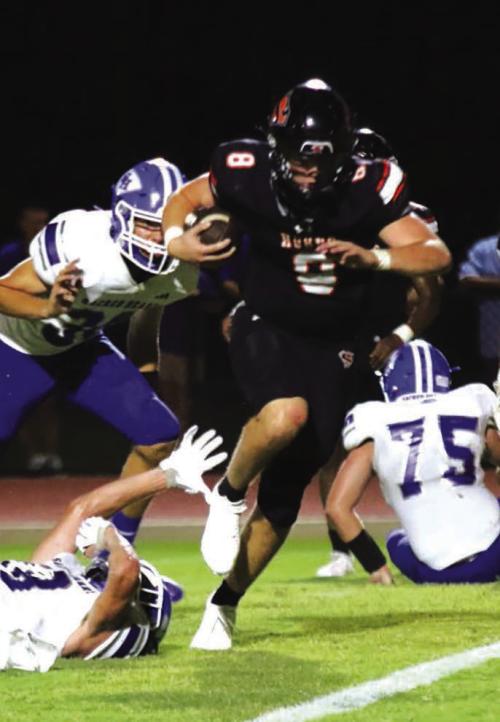Schulenburg quarterback Owen Brenek eludes several Sacred Heart Hallettsville tacklers on his way to a big night for the Shorthorns Friday. Photo by Audrey Kristynik