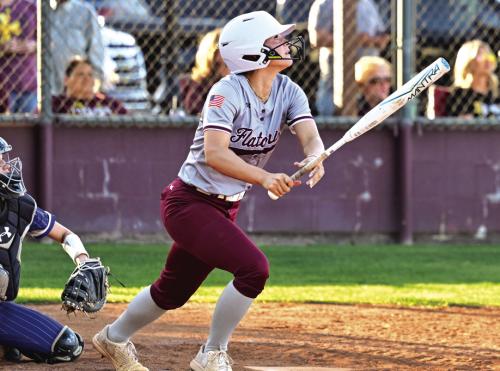 Jalee Trussell watches her ball go over the centerfield fence Tuesday night in Flatonia. The Lady Bulldogs defeated The Louise Lady Hornets for a district win. Photo by Stephanie Steinhauser