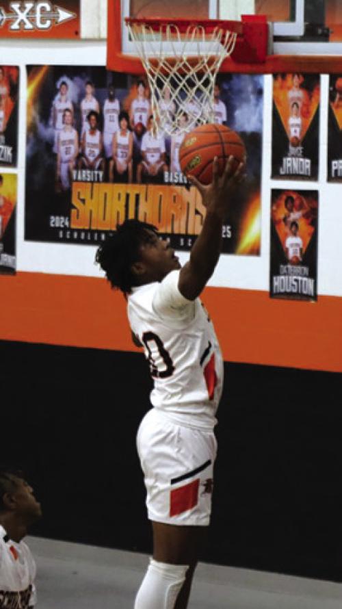 Daterrion Houston goes up for a basket in Friday’s 48-38 loss to Weimar in the district opener. Photo by Audrey Kristynik