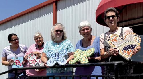 Some students in the mosaic class for Artful Friday grouted their projects recently, pictured left to right are Fernanda Kirkwood, Cynthia Meyer, Kitra Ruiz, Maryanne Jurica, and instructor Stephanie Shroyer.