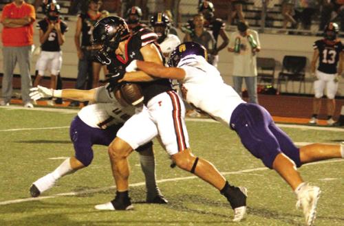 La Grange’s Cordale Knapik, left, and Ethan Tarnowski, right, combine to force a fumble Friday. Photo by Jeff Wick