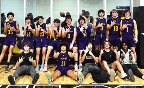 The members of the La Grange boys basketball team pose after Tuesday’s district-title-clinching victory at Navasota.