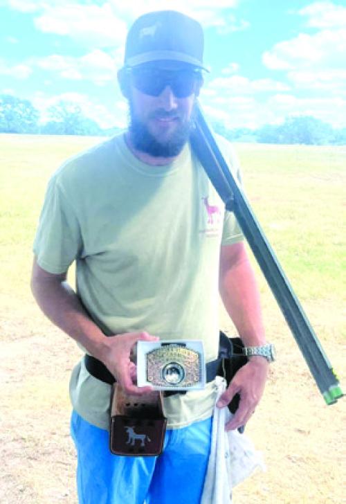 Steven McFarlin shows the buckle he won at the Clay and Turkey Shoot.