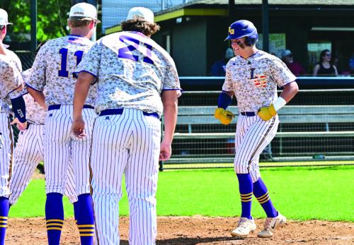 La Grange teammates wait for Hunter Sabo at home plate to celebrate his homerun putting the Leopards up 11-8 in the 6th inning of Game 2 with Sealy Saturday. Photo by Stephanie Steinhauser