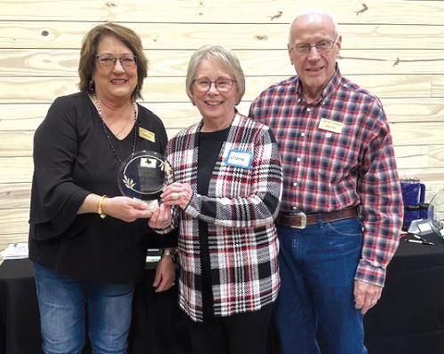 Pictured is Marlene Waak, left, presenting the Carmine Chamber of Commerce Business of the Year Award to Jane and James Press, owners of Pecan Grove Inn.