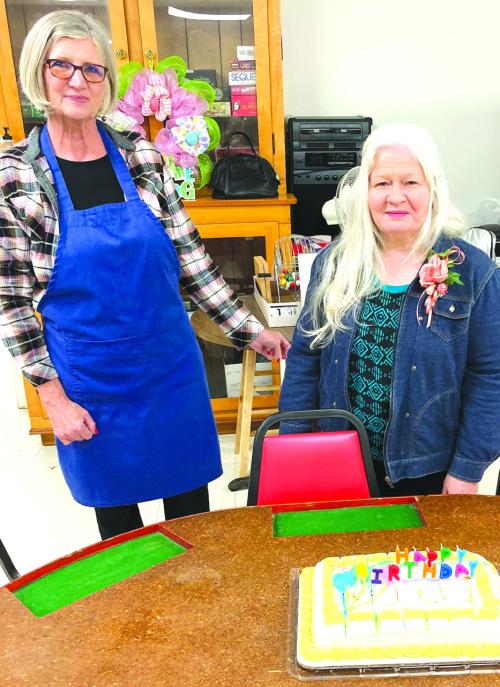 March birthdays of the month are Julie Clements in the blue apron and Angie Pekar celebrating their birthday at the center.