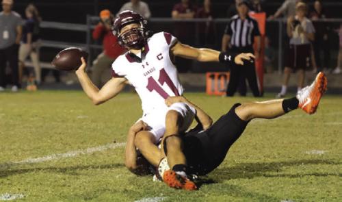 Ganado quarterback Bryce Ullman tosses the ball as he nearly gets sacked by Shorthorn defender Preston Kahn. The ball went out the back of the endzone, and officials ruled it a safety. Photo by Andy Behlen