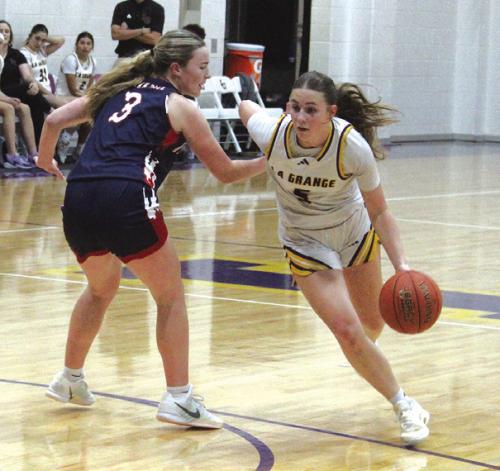 La Grange’s Campbell Cooper drives past Wimberley’s Bailey Whitten in last Tuesday’s game. Photo by Jeff Wick