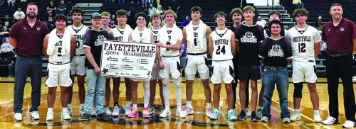 The members of the Fayetteville basketball team celebrate their Area title after Friday’s victory in Seguin.