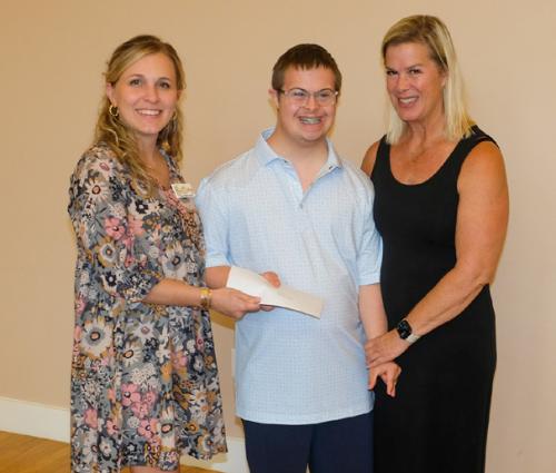 Brittany Siptak, left, presented a grant check to And Then a New Day, represented by Willy and Meg Keilbach.
